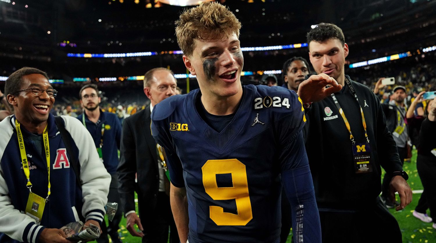 J.J. McCarthy walks off the field smiling